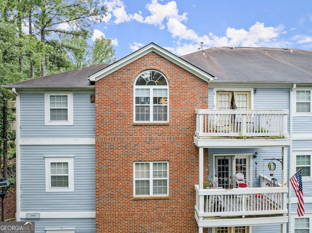 back of house featuring a balcony