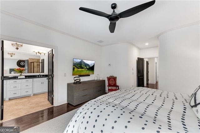 bedroom featuring ceiling fan, hardwood / wood-style flooring, sink, connected bathroom, and ornamental molding