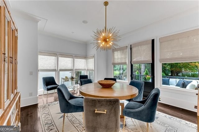 dining area with ornamental molding, a chandelier, and dark hardwood / wood-style flooring