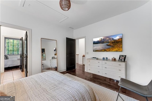 bedroom with dark hardwood / wood-style flooring