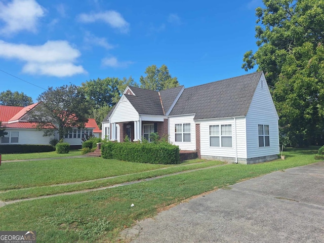 new england style home featuring a front lawn