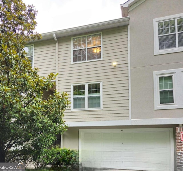 view of side of property with a garage