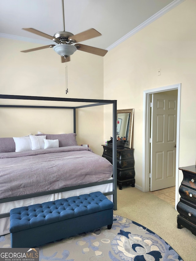 carpeted bedroom featuring ceiling fan, a towering ceiling, and crown molding