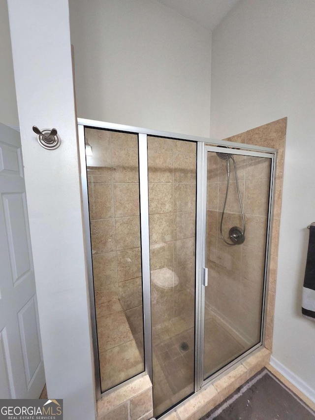 bathroom featuring a shower with shower door