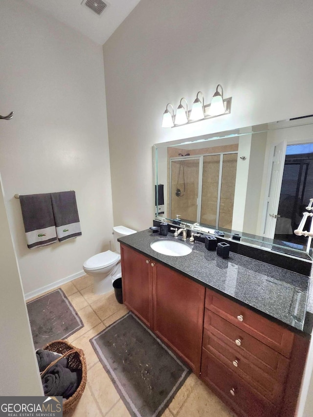 bathroom featuring toilet, tile patterned floors, and vanity