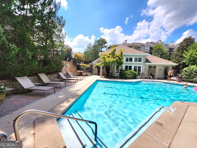 view of swimming pool featuring a patio area