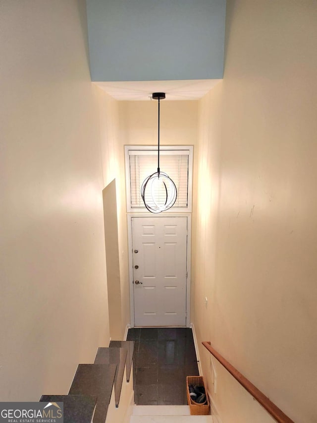 doorway with dark tile patterned flooring