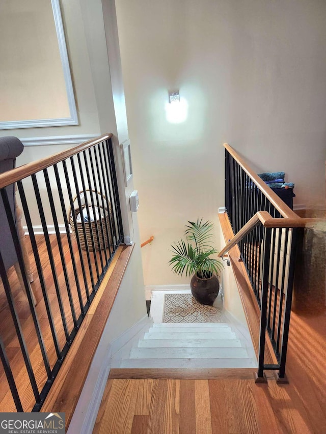 staircase featuring hardwood / wood-style flooring