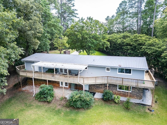 rear view of property with a lawn and a wooden deck