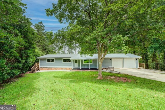 ranch-style house with a garage and a front lawn