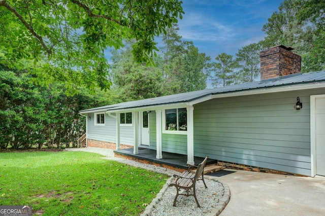 back of property featuring a lawn and a patio