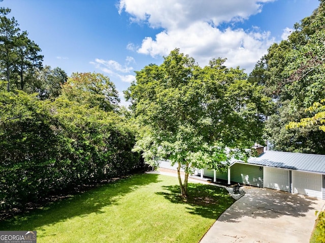 exterior space featuring a garage and a front lawn