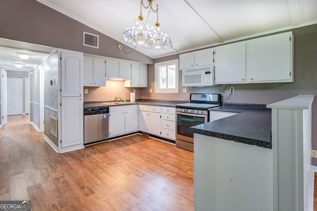 kitchen with appliances with stainless steel finishes, light wood-type flooring, white cabinetry, hanging light fixtures, and lofted ceiling