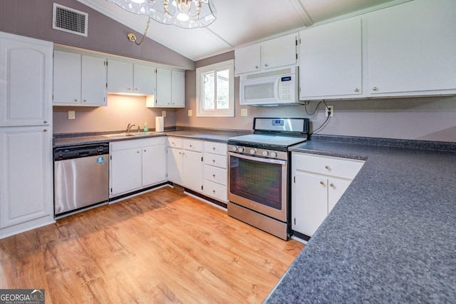 kitchen with sink, vaulted ceiling, light hardwood / wood-style floors, white cabinetry, and stainless steel appliances