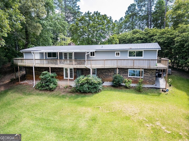 back of house featuring french doors, a yard, and a wooden deck