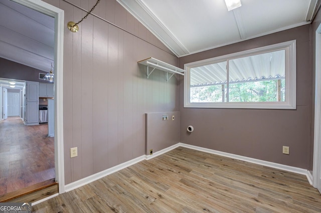 laundry room featuring washer hookup, wood walls, and wood-type flooring