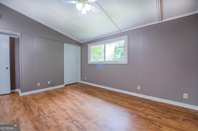 unfurnished bedroom with ceiling fan, light hardwood / wood-style flooring, and lofted ceiling