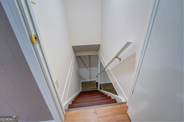 stairs featuring hardwood / wood-style flooring