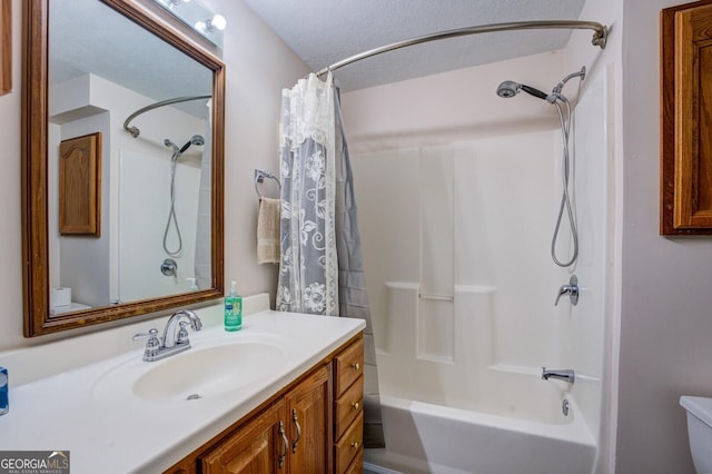 full bathroom with a textured ceiling, vanity, shower / tub combo, and toilet