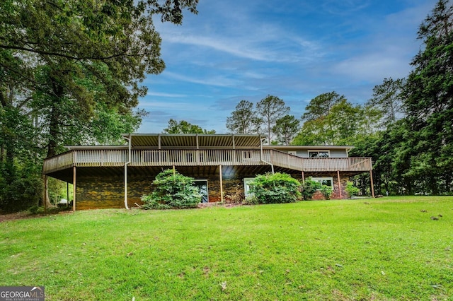 rear view of property with a lawn and a deck