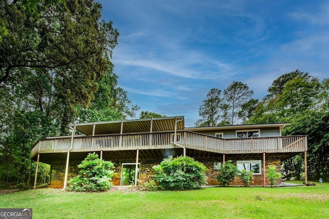 back of house featuring a yard and a deck