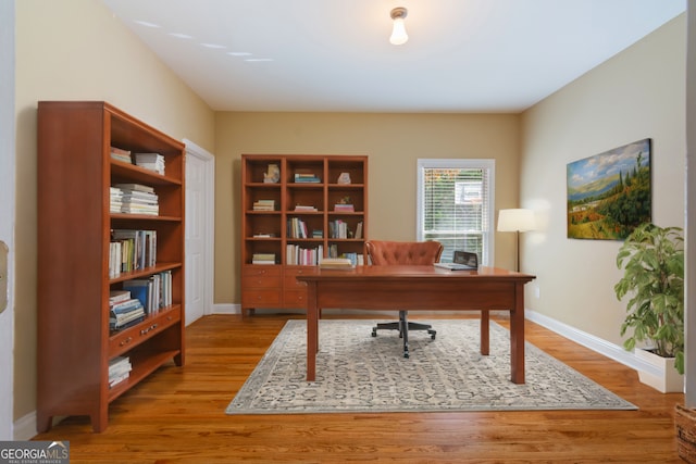 office area with wood finished floors and baseboards