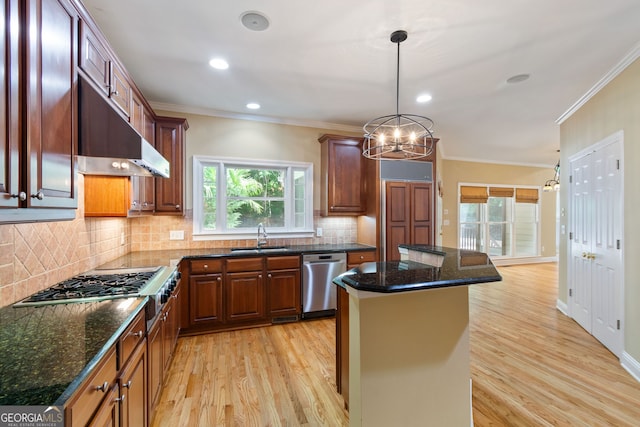 kitchen with a center island, sink, light hardwood / wood-style flooring, and stainless steel appliances