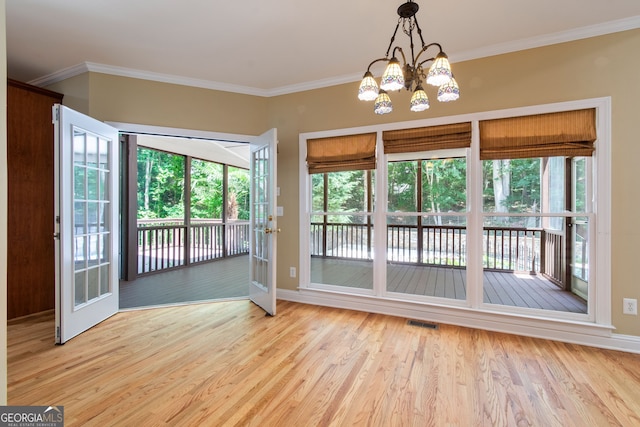 unfurnished dining area with ornamental molding, visible vents, and wood finished floors