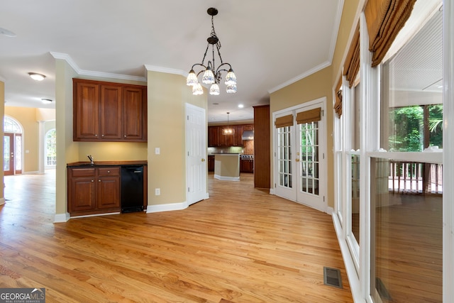 kitchen featuring dishwasher, light hardwood / wood-style flooring, and a healthy amount of sunlight