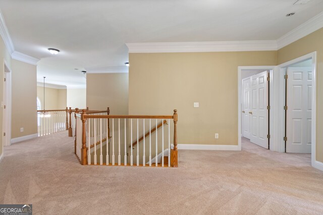 corridor featuring crown molding and light colored carpet