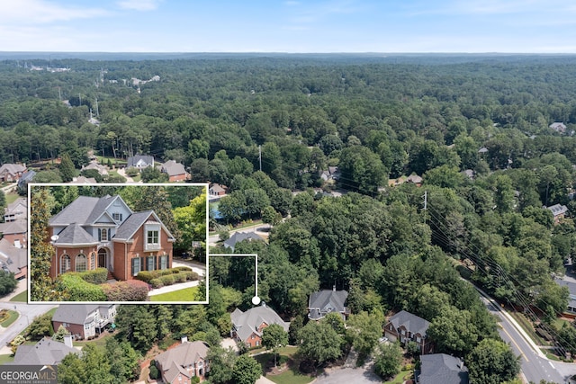 birds eye view of property featuring a view of trees