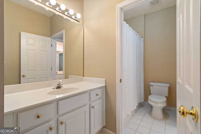 bathroom featuring vanity, tile patterned flooring, and toilet