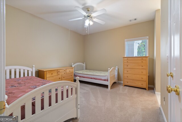 bedroom featuring light carpet and ceiling fan