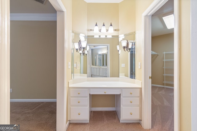 bathroom with visible vents, ornamental molding, vanity, and baseboards