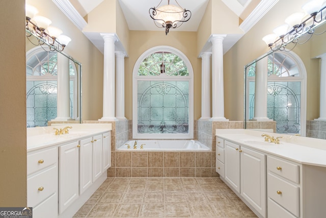 full bathroom with a chandelier, a sink, ornate columns, and a bath