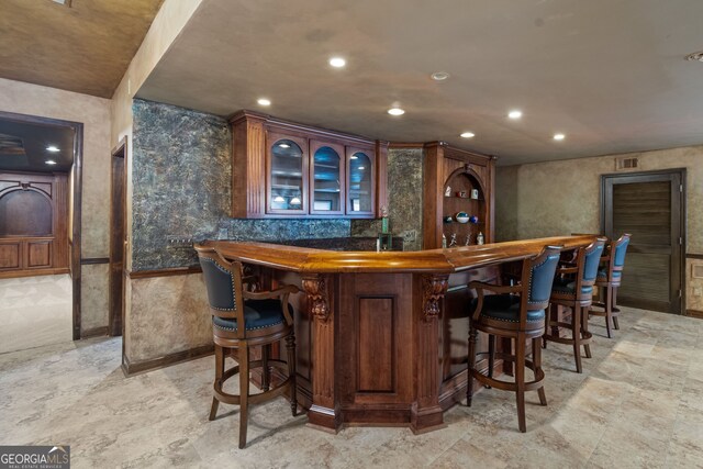 bar featuring light tile patterned floors