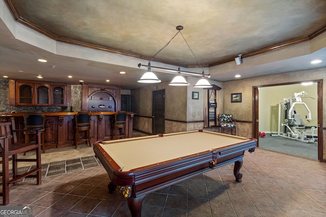 game room featuring recessed lighting, a tray ceiling, crown molding, and dark tile patterned flooring