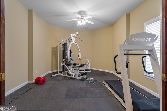 workout area with a ceiling fan, baseboards, and a wealth of natural light