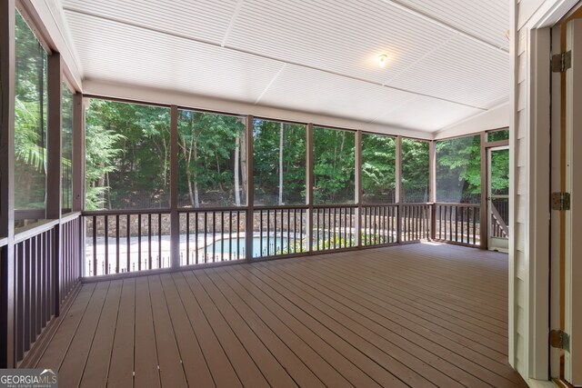 unfurnished sunroom with vaulted ceiling