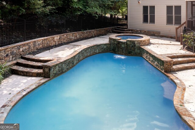 view of swimming pool featuring an in ground hot tub