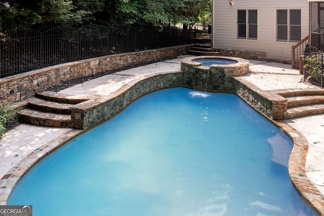 view of swimming pool with a pool with connected hot tub and fence