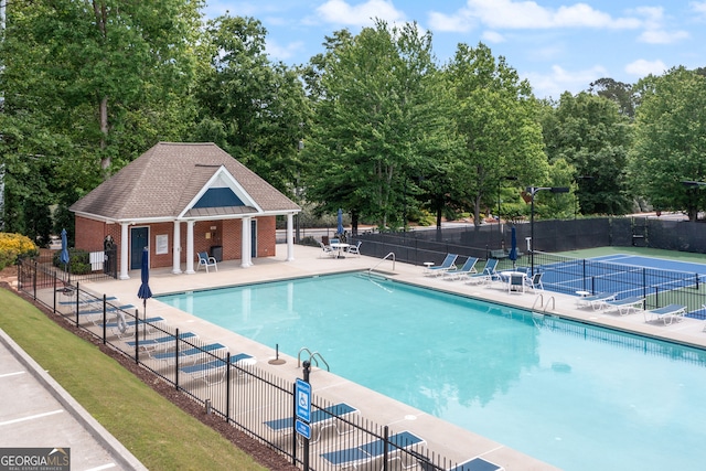 view of pool with a patio and an outdoor structure