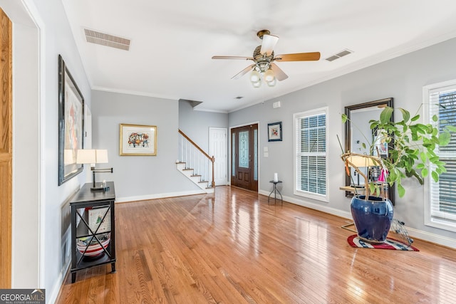 foyer entrance featuring a healthy amount of sunlight, hardwood / wood-style flooring, and ceiling fan