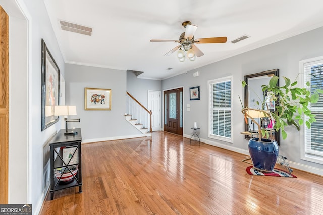 foyer entrance featuring stairway, wood finished floors, and visible vents