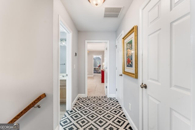 corridor with baseboards and visible vents