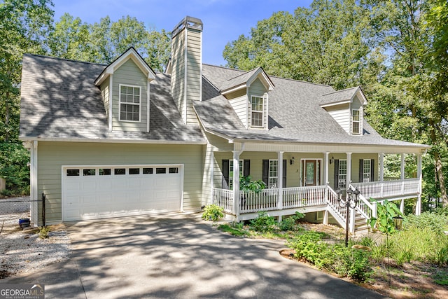 cape cod house with a garage and covered porch