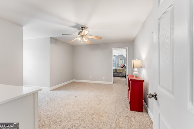 carpeted spare room featuring ceiling fan