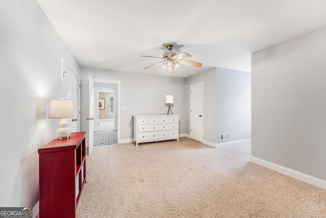 carpeted bedroom featuring baseboards, visible vents, and ceiling fan