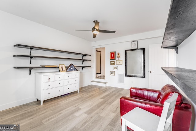 sitting room with ceiling fan and light hardwood / wood-style flooring