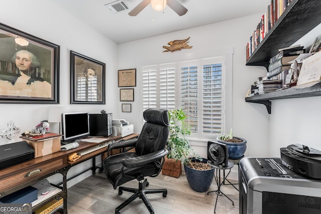 home office with washer / clothes dryer, ceiling fan, and wood-type flooring